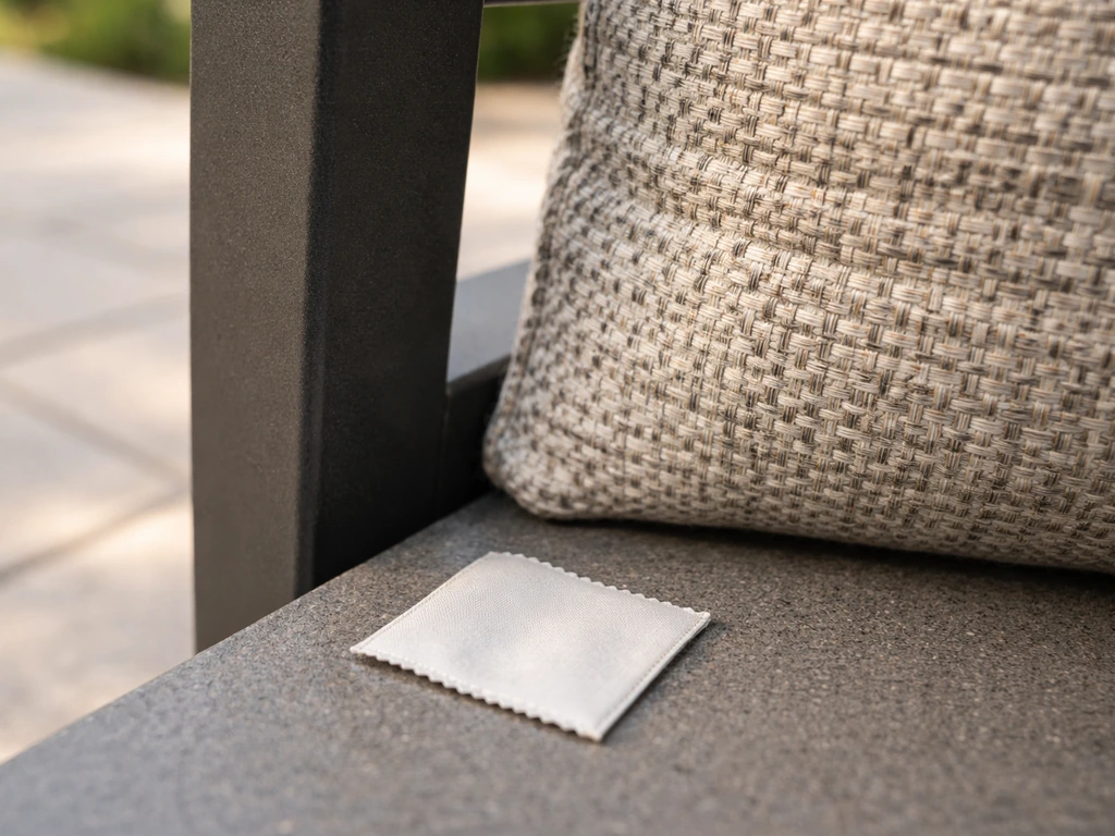Close-up of a powder-coated aluminum patio furniture frame and fabric with a small materials tag